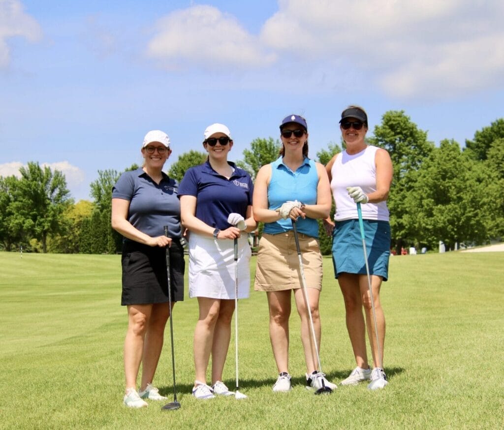 A parent foursome at the NDA Golf Tournament.